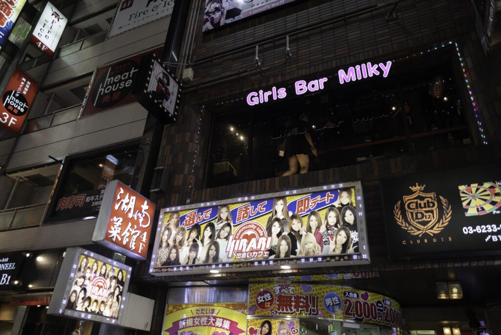 Night view of Kabukicho in Shinjuku, Tokyo, featuring colorful signs and a girls bar.