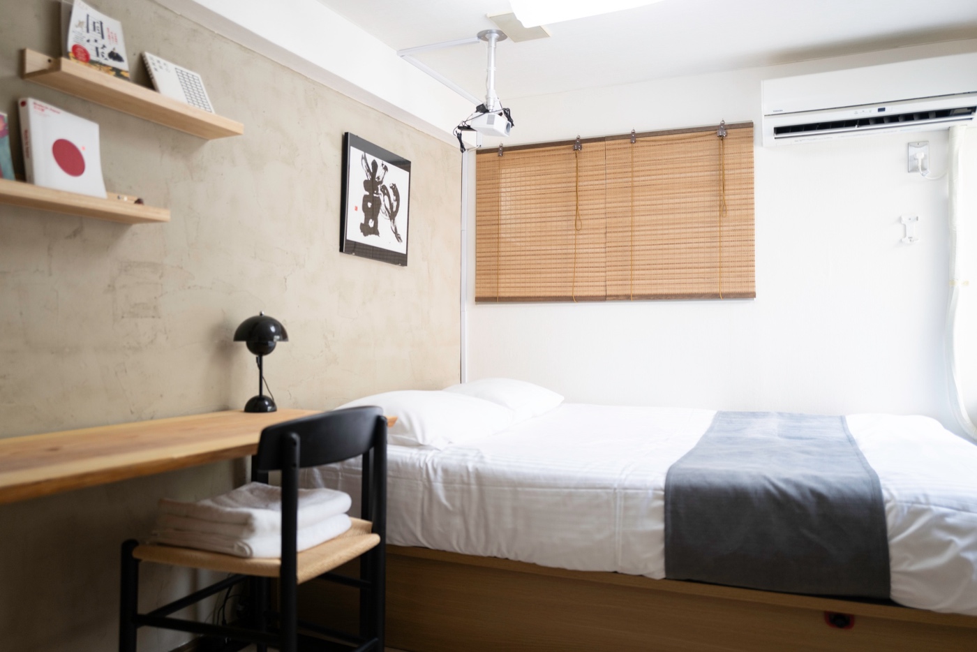 Kaku Studio Flat 103 in Ikebukuro — minimalist Japanese interior with concrete walls and calligraphy art